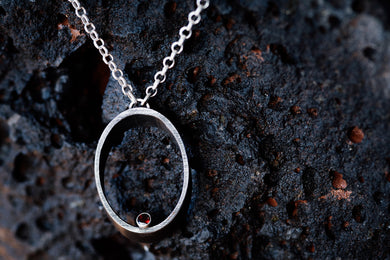 Hera necklace made of steel, silver, and garnet oval necklace pendant and a long silver necklace chain