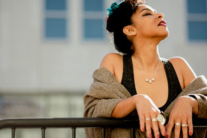 Model wearing Triple Horizontal Broken Silver Necklace and other sterling silver jewelry, multiple silver rings