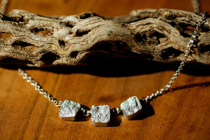 Close up of triple silver necklace stones on a short necklace chain made with Zink Metals’ broken silver technique