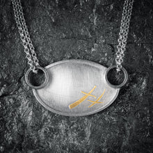 Load image into Gallery viewer, Close up on XOXO necklace in silver and gold