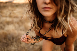 Woman wearing doubled large chain link necklace 