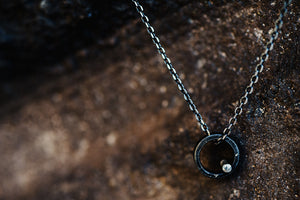 Single circle necklace with steel and silver pendant and 18” sterling silver chain necklace with black ruthenium