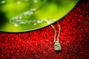 Close up of broken sterling silver pendant necklace with 18” chain